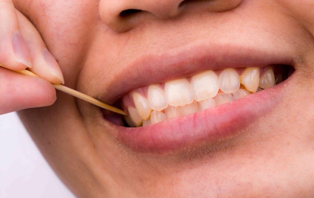 Woman using a toothpick